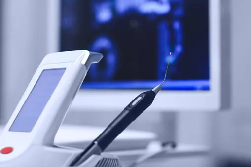 dentist-holding-dental-curing-ultraviolet-light modern